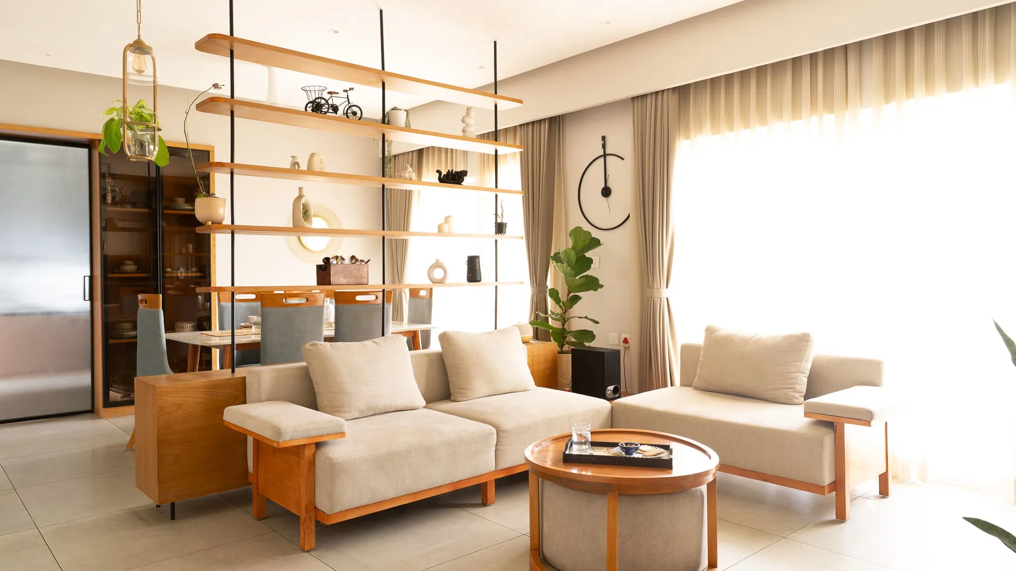 Living area with wooden-frame sofa and open shelving partition